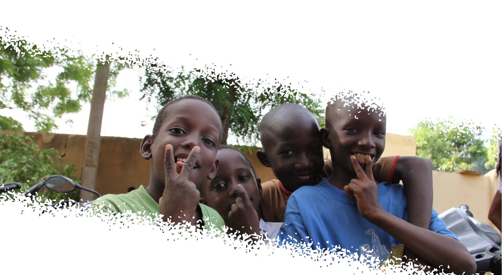 Children smiling and making peace signs
